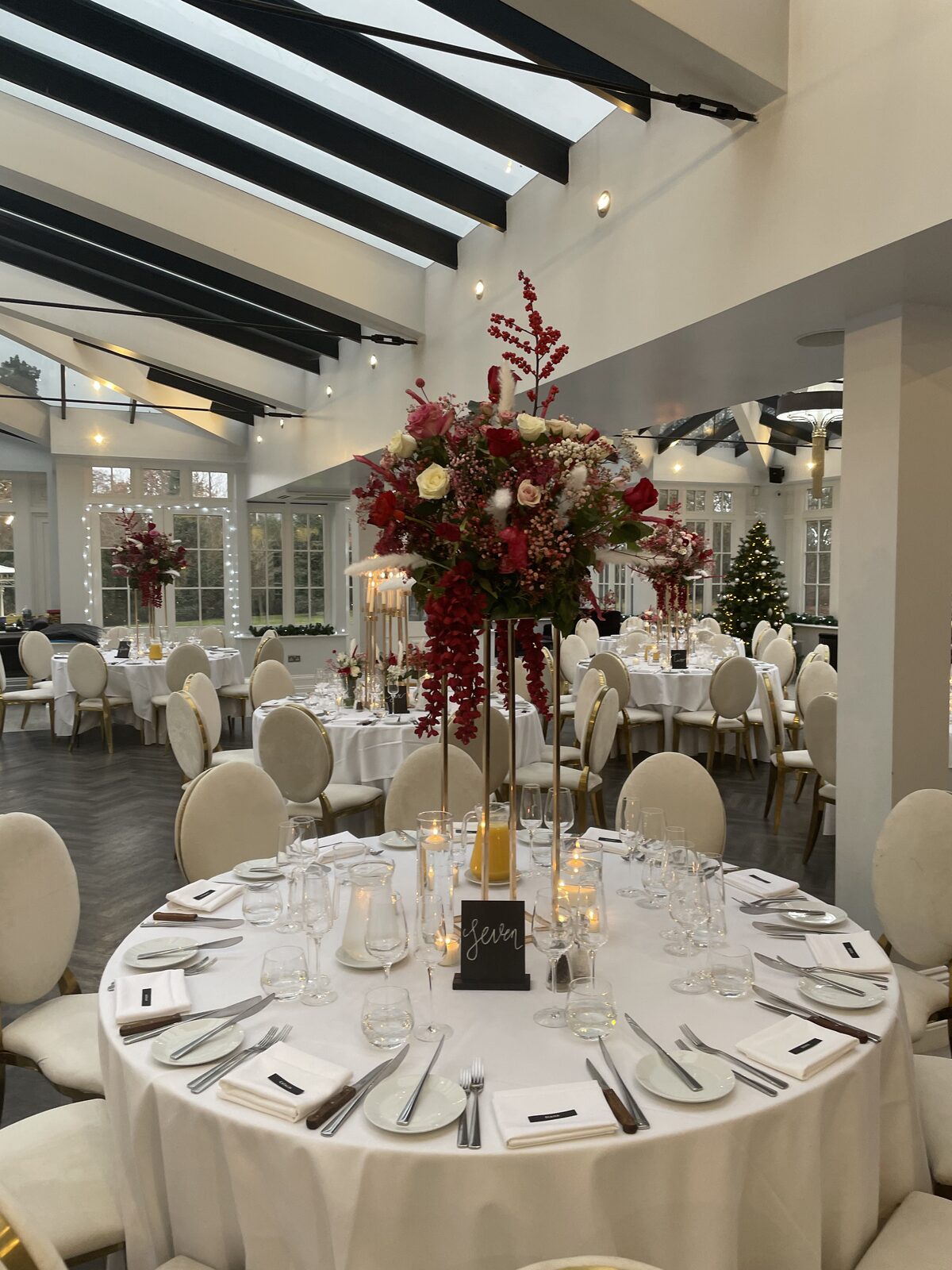 Tall red and pink centrepiece at a winter reception