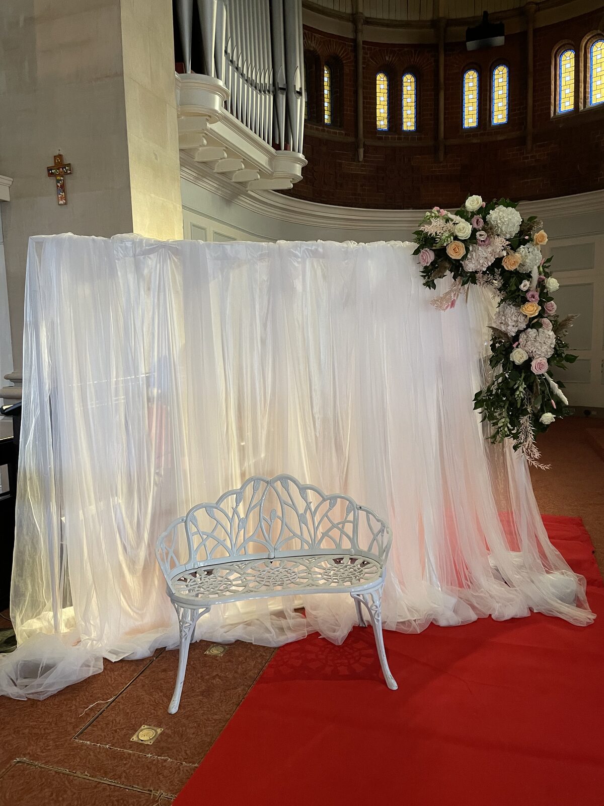 Church ceremony backdrop with floral arch