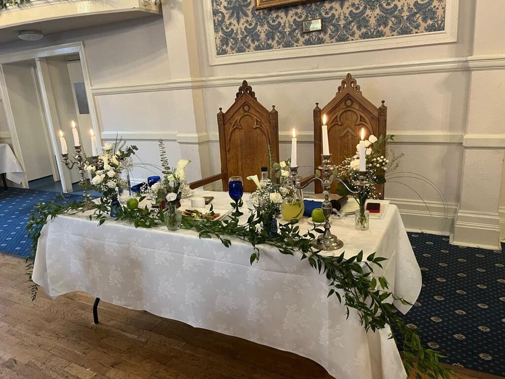 Long top table with candelabra and florals