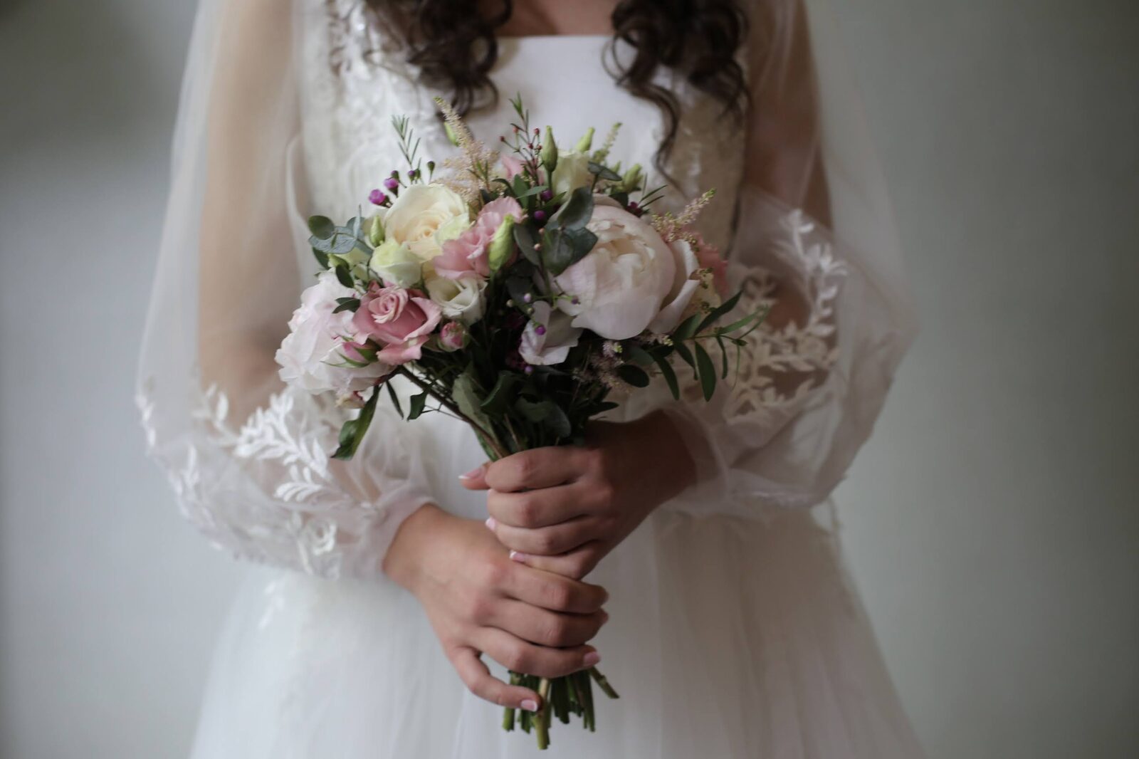 Bride holding a soft pink and cream bridal bouquet