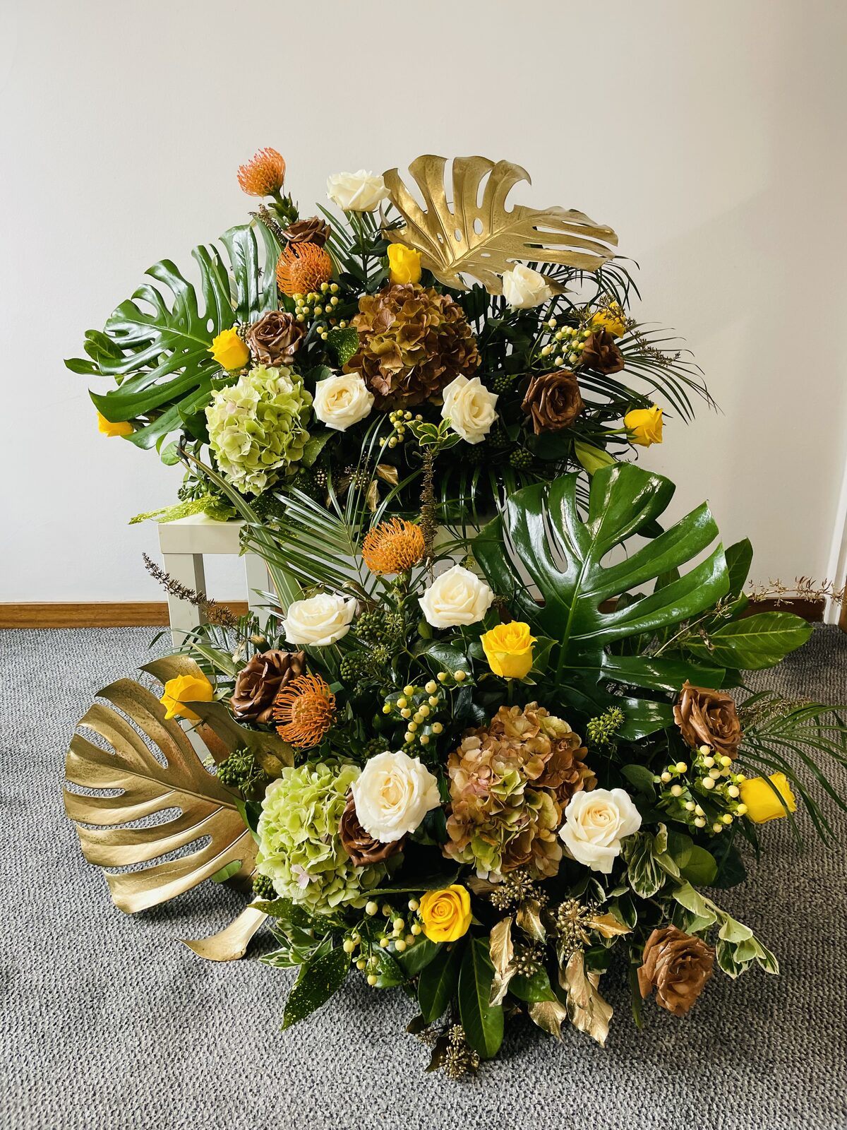 Standing tribute arrangement with gold foliage